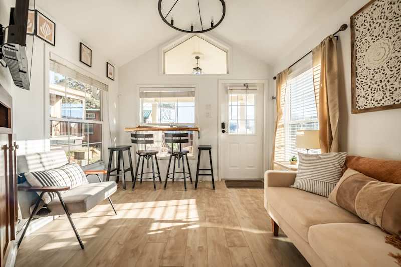 Beautifully bright living room with natural sunlight entering from the west side of home